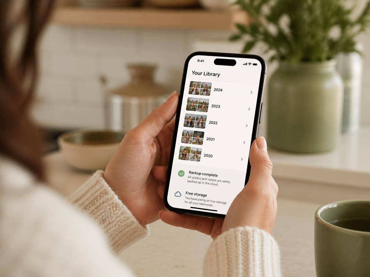 Smartphone photo library organized into albums by year with cloud backup complete and free storage available